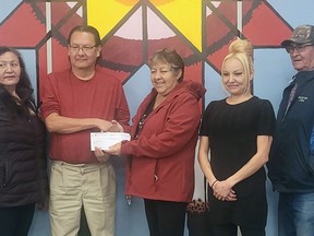 The creators of 6 MIlet Haunted House presented Samson Food Bank representative Janet Swampy with a $1,025 donation.