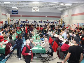 People fill the gymnasium at Our Lady of the Rivers Catholic School, which was formerly known as Father Turcotte School, for the annual Christmas meal hosted by the Fort McMurray Knights of Columbus on Wednesday, December 25, 2019. Vincent McDermott/Fort McMurray Today/Postmedia Network