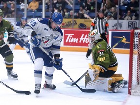 Ethan Larmand (45) of the Sudbury Wolves battles for the puck with Brayden Hislop (3) of the North Bay Battalion in front of Battalion goalie Dom DiVincentiis (31) during OHL action at Sudbury Community Arena in Sudbury, Ontario on Friday, December 30, 2022.