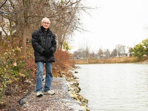 Chatham resident Tony Hill stands on top of a gabion wall structure he built at the edge of his property on the Thames River Nov. 18, 2022. (Tom Morrison/Chatham This Week)