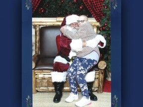 Karen Hall poses alongside Santa Claus inside the Quinte Mall in Belleville, Ontario. Submitted.