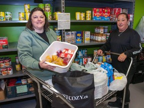 Intake co-ordinator Molly MacDonald (left) and delivery co-ordinator Serena Carley organize donations at the Stratford House of Blessing. (Chris Montanini/Stratford Beacon Herald)