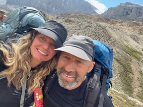 Chris Gore, right, poses for a photo while on a hike with his wife, Gillian Schultze.