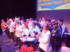 The REACH Centre Grey Bruce Choir performs along with members of the Owen Sound Police Service at the 83rd annual CFOS-Sun Times Christmas Fund Broadcast at the Roxy Theatre in Owen Sound on Sunday, December 4, 2022.