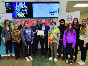 Representatives of the Black Gold school board, teachers, and students unveiled the certificate of the new solar panel roof at West Haven Public School, November 28. (Dillon Giancola)