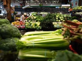 A woman shops for produce at the Granville Island Market in Vancouver, on Wednesday, July 20, 2022. Food prices in Canada will continue to escalate in the new year, with grocery costs forecasted to rise up to seven per cent in 2023, new research predicts.THE CANADIAN PRESS/Darryl Dyck