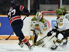 Goaltender Dom DiVincentiis of the North Bay Battalion foils Michael Misa of the Saginaw Spirit in Ontario Hockey League action Sunday. Penalty killers Nikita Tarasevich and Ty Nelson of the host Troops have a good vantage point.