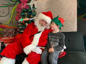 Seven-year-old Kyler tells Santa what is on his Christmas list Saturday at OutLoud.