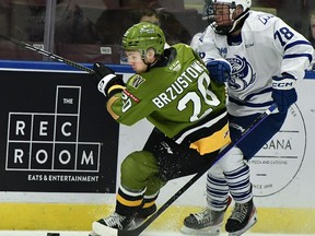 Luc Brzustowski of the visiting North Bay Battalion does battle with MacGregor Richmond of the Mississauga Steelheads in Ontario Hockey League action Friday night. The Troops host the Saginaw Spirit at 2 p.m. Sunday.