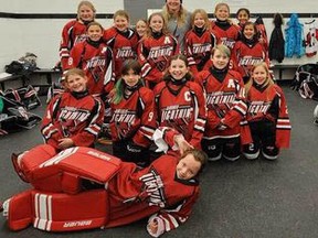 The U11A Airdrie Lightning girls take a group photo with Hayley Wickenheiser, who paid them a visit in the dressing room before the girls hit the ice at Wickfest.