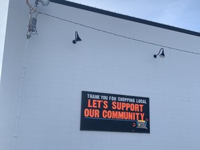“Let's Support our Community” sign in downtown Peace River on Nov. 30, 2022.