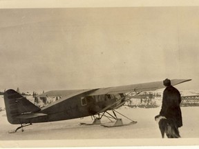 73.561.j2 – A float equipped bush plane, A1A, (uncertain of its exact pedigree – appears to a Bellanca authorized for mail carrying) rests, untethered, on frozen Peace River, perhaps ready for imminent takeoff. Date uncertain, but sometime after 1918 (re: railway bridge) and wooden water tower on west side of river (abandoned after steam engines gave way to diesel in 1950s). Man reported to be Punch Dickins – canine companion’s name unknown. It is known Dickins was in Peace River in 1931 – delivered a Bellanca to replace a Fokker involved in a mishap.