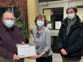 Charlie Slade, left, receives the Norm Lachapelle Award for Volunteerism from Linda Lachapelle, centre, and her son Martin Lachapelle at Riverview Gardens in Chatham. Slade has volunteered for over 1,700 hours at the long-term care facility. (Handout/Postmedia Network)