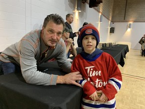 Avery Turgeon of St. Thomas, right, has a visit with retired Montreal Canadiens winger Stephane Richer on Dec. 2 in Lucan. The Canadiens Alumni team visited the Lucan Biddulph Community Memorial Centre to mark the 70th anniversary of when the Habs played against the Lucan Irish Six in a 1952 exhibition game. Scott Nixon