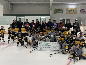 ‘Gooday Let’s Play’ representative Tim Horvat (son of John Horvat, and father of Vancouver Canucks Captain and Rodney native Bo Horvat) presents a cheque to players of the West Lorne Minor Hockey Initiation Program (U5/U7), which covers all the registration fees for the first-year players. Photo by MaryJo Tait