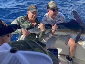 Jeff Poperechny and Jamie Bruce with a marlin from the Pacific Ocean.