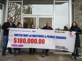 Members of the Procter & Gamble campaign committee hold a cheque with their annual amount raised towards United Way Hastings Prince Edward. ALEX FILIPE