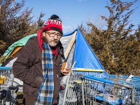 Donnie stands in front of his tent on Dec. 9th in Belleville, Ontario. This will be his first winter living outside as he tries to gather funds to travel back home to Alaska. ALEX FILIPE