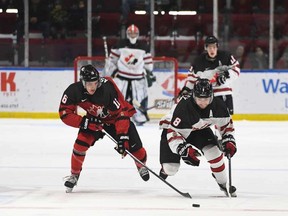 Canada East forward Samuel Assinewai (16) pursues Canada West defenceman Breck McKinley (8) during round-robin play at the World Junior A Challenge in Cornwall, Ontario on Monday, December 12, 2022.