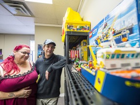 Sarah Hygaard and Derrick Weeks stand alongside some of their collectable Lego sets inside their newly opened store 2 Many Bricks on Tuesday in Belleville, Ontario. ALEX FILIPE