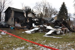 Fire crews had to bring in a backhoe to tear down the back of a Tavistock home as they worked to extinguish an overnight fire early Tuesday morning.  (Galen Simmons/The Beacon Herald)