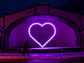Stratford couple David and Jody Smiling walk by a glowing heart on display near the Avon River. The heart can be found along the Light Trail organizers of the Lights on Stratford Festival have set up between Market Square and Tom Patterson Island. (Chris Montanini/Stratford Beacon Herald)