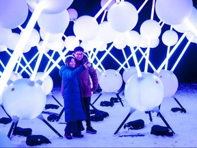 Zoie Wong and Tim Lee, visitors from Toronto, are bathed in light Tuesday evening as they take a selfie at Affinity, the interactive Australian light sculpture on Stratford’s Tom Patterson Island. Affinity is one of the main attractions in this year’s Lights On Stratford festival. (Chris Montanini/Stratford Beacon Herald)