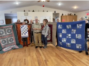 Trout Creek Friendship Club members (left to right) Joanne Kluke, Janet Gagne, Francis Warner, Leslie Ann Ciglen and Diane McGee holding quilts they made for clients of Christian Horizons in Sundridge.  Pictured in the foreground are Christian Horizon worker Kelsi Hilton (far right) and two group home clients Nathalie Viau and David Cadeau.