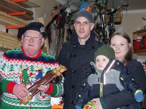 Dutton Dunwich Town Crier David Phillips, left, is shown with  Matt, Katie and Walter Routliffe. Walter is battling a form of cancer and a tree-lighting event was held to show support for the family. (Handout/Postmedia Network)