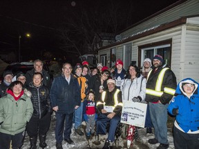 Members of the Rushlow family are joined alongside Belleville Mayor Neil Ellis and Coun. Garnet Thompson as well as members from the Belleville and Quinte West Special Olympics Community on Tuesday evening in Belleville, Ontario. ALEX FILIPE