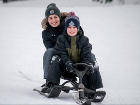 Maren Marshall, 13, and her brother Miles, 10, are all smiles while they race down a hill in Stratford’s Upper Queen’s Park on Tuesday. Chris MontaniniStratford Beacon Herald