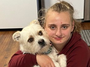 Josee holds Casper, one of the family pooches. Josee's family is hailing her courageous actions on Christmas morning, and crediting her with saving them and their home.