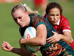 Maddison Levi of Australia is tackled by Breanne Nicholas of Canada on Day 1 of the HSBC World Rugby Sevens Series - Dubai at The Sevens Stadium on December 02, 2022 in Dubai, United Arab Emirates. (Photo by Christopher Pike/Getty Images)