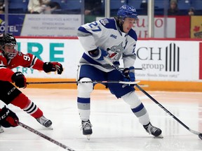 Daniel Michaud of the Niagara IceDogs battles for the puck  with Quentin Musty of the Sudbury Wolves during OHL action at Sudbury Community Arena in Sudbury, Ontario on Sunday, December 4, 2022. Gino Donato For The Sudbury Star