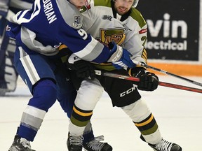 Goaltender Dom DiVincentiis of visiting battalion North Bay receives a leg in a shot on goal by Ontario Hockey League's Sudbury Wolves Nick DeGrazia on Friday night. The troops host the Oshawa Generals in their New Year's Eve game at 1:00 p.m. Saturday.