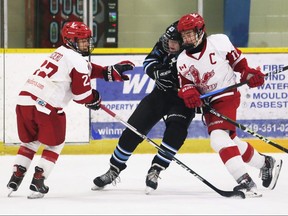 Kent Cobras' Brock Mailloux (24) is sandwiched by Toronto Eagles' Aidan Asher (17) and Thomas Arciero (27) during a U16 AA semifinal at the Chatham Regional Silver Stick Tournament at Thames Campus Arena in Chatham, Ont., on Sunday, Dec. 11, 2022. Mark Malone/Chatham Daily News/Postmedia Network