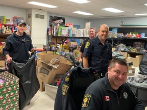 Owen Sound firefighters packed bags with kids' toys Wednesday, Dec. 7, 2022 in preparation for pickup next week. From left: Matt Pullen, Wayne Flood, Andrew Cooper and Matt Given. (Supplied)