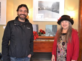 Artist Ruben Arroyo stands with gallery owner Annie Froese in front of a couple of his favourite paintings.