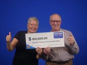 Margrit Ann Olson and Scott Grant with their winners cheque.