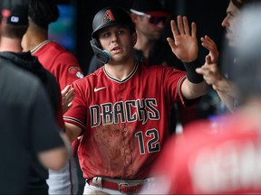 Daulton Varsho of the Arizona Diamondbacks celebrates in the dugout after a second inning run scored against the Colorado Rockies at Coors Field on July 3, 2022 in Denver, Colorado.
