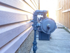 Side view of a residential urban natural gas meter.