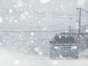 Whiteout Conditions - Getty stock photo. Motorists navigate a city street in white out conditions.