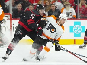 Carolina Hurricanes defenceman Brady Skjei (76) pokes the puck away from Philadelphia Flyers right-winger Travis Konecny (11) during the first period at PNC Arena in Raleigh, N.C., on Dec. 23, 2022. (James Guillory-USA TODAY Sports)