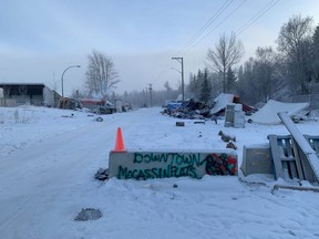 A concrete barrier which has "Downtown Moccasin Flats" painted on it