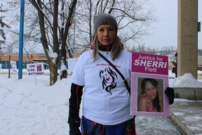 Denise Krueger holds a photo of her late cousin, Sherri Lynn Flett, outside the Fort McMurray court house on February 28, 2022. Vincent McDermott/Fort McMurray Today/Postmedia Network