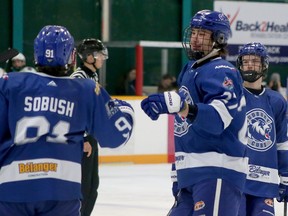 Greater Sudbury Cubs forward Cole Crowder (27) congratulates teammate Pierson Sobush (91) for his first-period goal against the Espanola Paper Kings during NOJHL action at Gerry McCrory Countryside Sports Complex in Sudbury, Ontario on Thursday, December 15, 2022.