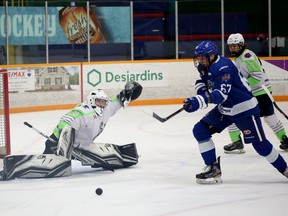 Espanola Paper Kings goaltender Jake Marois (31) stretches to make a save while Greater Sudbury Cubs forward Oliver Smith (67) looks for a rebound during NOJHL action at Gerry McCrory Countryside Sports Complex in Sudbury, Ontario on Thursday, December 15, 2022.