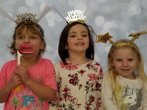 At the photo booth during the return of the city's annual New Year's Eve family celebration, from the left, are friends Grace Cober, 5, of Owen Sound, Adaline Harris, 5, of Markdale, and Aria Gross, 5, of Owen Sound, at the rec centre Saturday, Dec. 31, 2022 in Owen Sound, Ont.(Scott Dunn/The Sun Times/Postmedia Network)