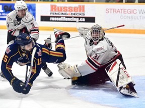 Jacob Frasca dives after taking a shot on Nick Chenard while Teddy Sawyer looks on as the Owen Sound Attack host the Barrie Colts inside the Harry Lumley Bayshore Community Centre on Friday, Dec. 30, 2022. Sam Buschbeck photo/Attack Hockey
