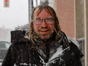 Sun Times carrier Shawn McDonald walked downtown through a snow squall during a blizzard warning on Friday, Dec. 23, 2022 in Owen Sound, Ont. (Scott Dunn/The Sun Times/Postmedia Network)